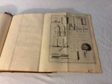 an open book with drawings on it sitting on a table