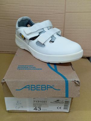 une image représentant une paire de chaussures blanches posée sur une boîte
