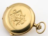an image of a gold pocket watch on a white surface