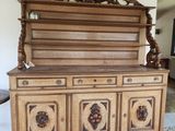 a wooden cabinet that has a wine bottle on top of it