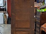 a tall wooden grandfather clock in the middle of a room