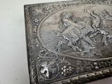 a silver box with a picture of a man riding a bull