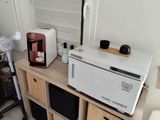 a microwave and a toaster sitting on a table