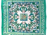 a green and white scarf with birds and flowers on it