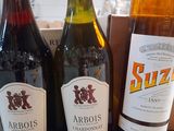 three bottles of wine sitting on top of a table next to a bottle of wine