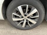 a close up of a tire on a white car