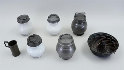 many different types of pots and containers on the table