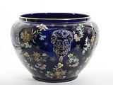 a blue vase with a floral design on it