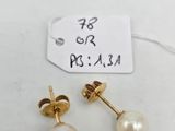 a pair of pearl earrings on a white background