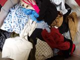 a pile of clothes that is sitting on the floor