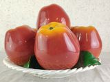a bowl of tomatoes on a table with a white table cloth