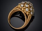 a close up of a gold and diamond ring on a black surface