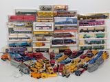 a lot of toy trains and trucks in a display case