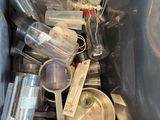 a trash can full of empty plastic bottles and spoons