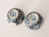 pair of blue and white vases sitting on top of a white table