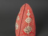 a red and white triangular shaped object on a black surface