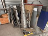 a pile of assorted metal items in a garage