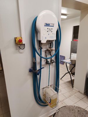 a blue hose attached to a white wall in a room