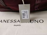 an image of a bag with a tag on it sitting on a table