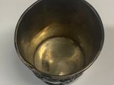 a silver cup that is sitting on a table