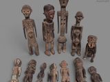 a group of wooden figurines sitting on top of a gray surface