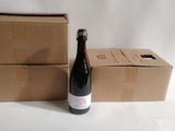 a bottle of wine sitting next to two boxes