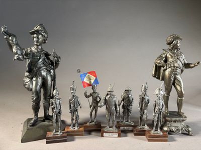 a lot of statues that are on display on a table