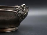 a silver bowl that is sitting on a table