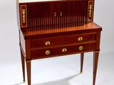 a small desk with a drawer on top of it