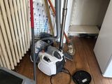 a vacuum and a broom in a room with a radiator