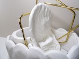 a white toilet with a gold frame around it