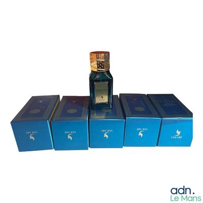 several boxes of perfumes are stacked on top of each other