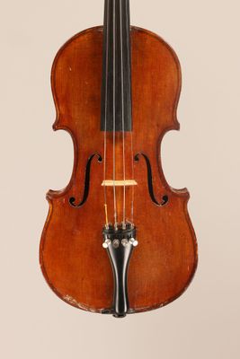 an old violin with a bow hanging from it ' s neck