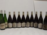 several bottles of wine are lined up in a row on a table