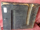 an old wooden picture frame on a red chair