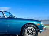 a blue car that is parked on the side of the road