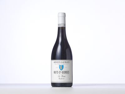 a bottle of red wine sitting on top of a table