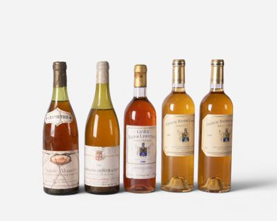 several bottles of wine are lined up on a white surface