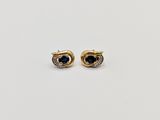 a pair of gold and sapphire earrings