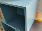 a blue shelf that is on top of a wooden table