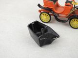 a small toy car and a small boat on the floor