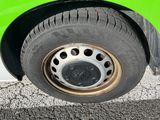 a close up of a tire on a green car
