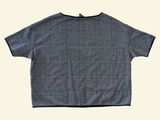 the back of a black and white checkered shirt on a white background