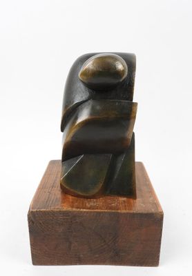an image of a sculpture on a wooden base on a white background