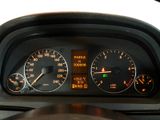 a close up of a car dashboard with a speedometer and gauges