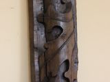 a wooden sculpture on the wall of a room