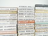 many books stacked on top of each other on a table