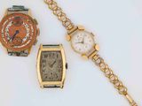 two watches and a bracelet are sitting next to each other