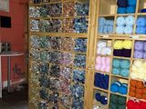 many balls of yarn on the shelves in the store