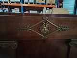 a wooden cabinet that has a decorative design on it